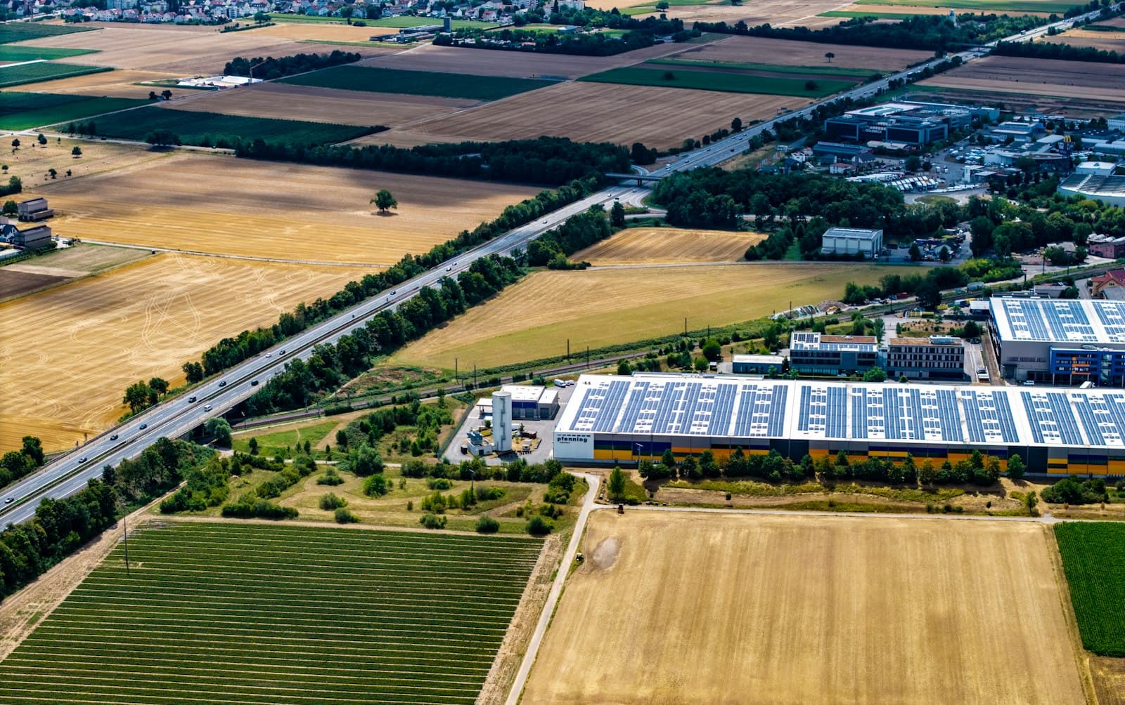 Drone photograph of a commercial building with rooftop solar panels